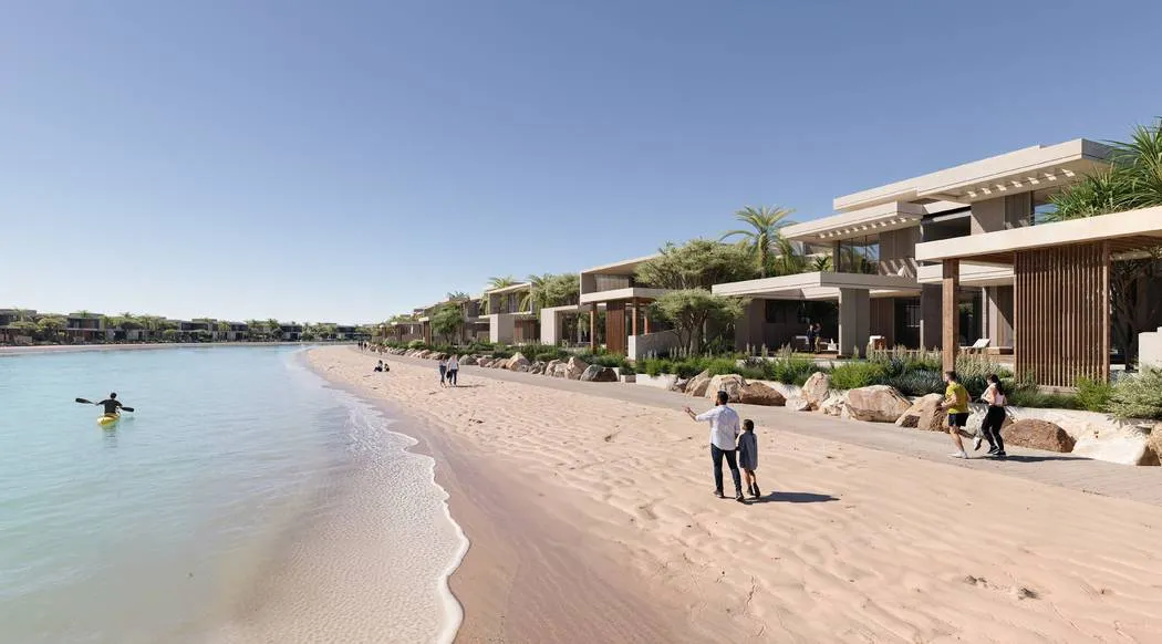 People walking on the canal beach beside the villas